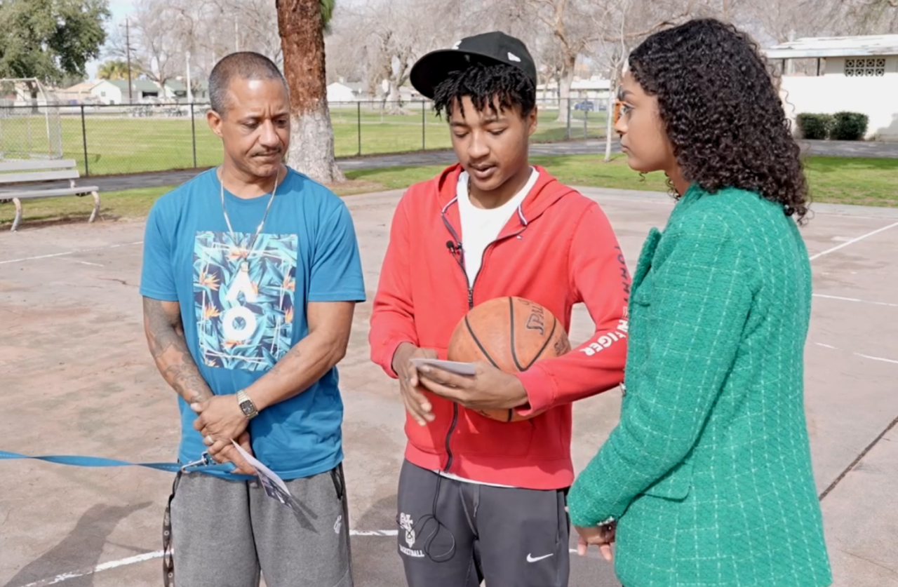 Bakersfield Neighborhood News Reporter Dominique Lavigne talking with family of victim at Wilson Park
