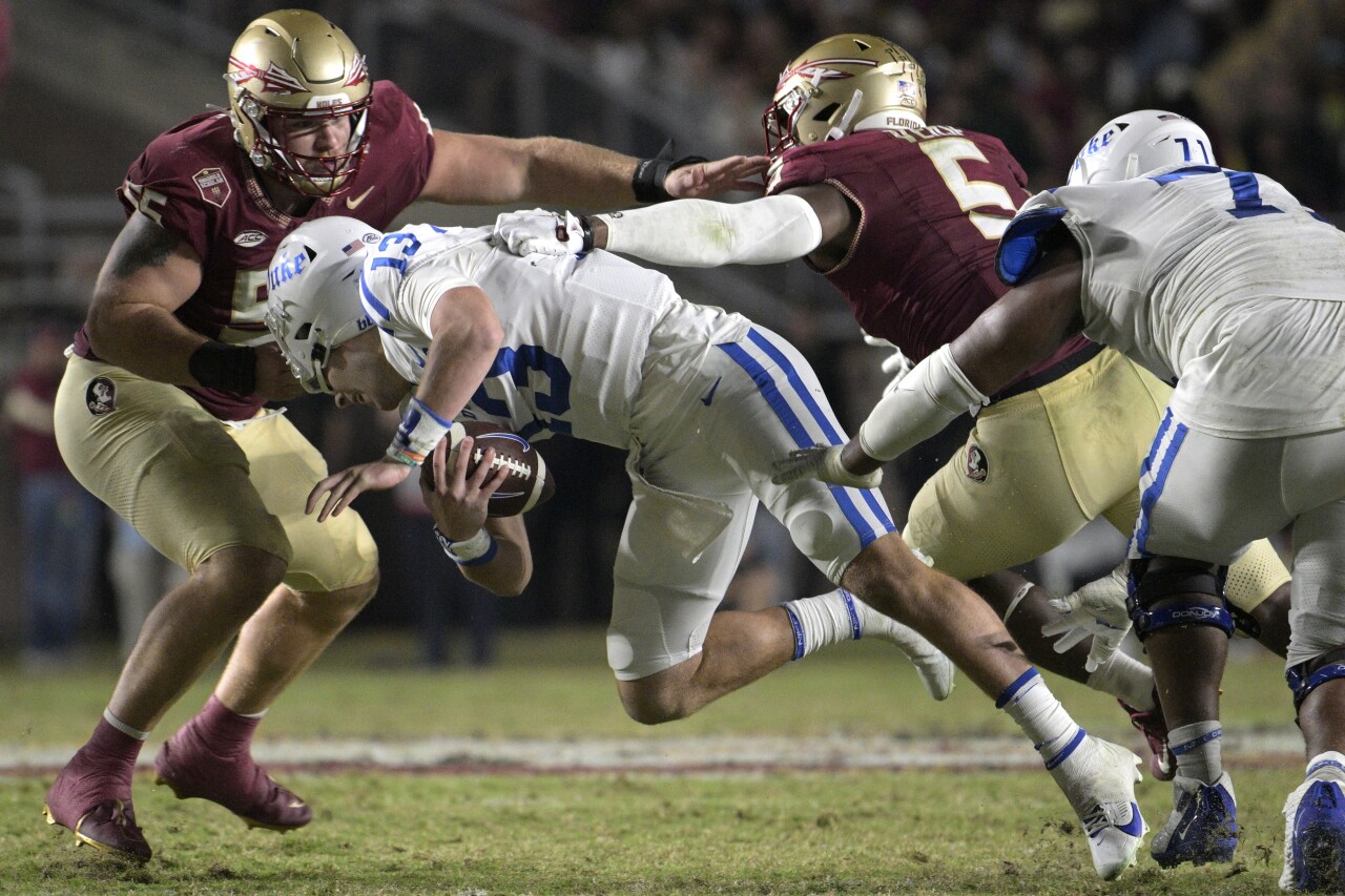 Duke Blue Devils QB Riley Leonard pulled down by face mask by Florida State Seminoles defensive lineman