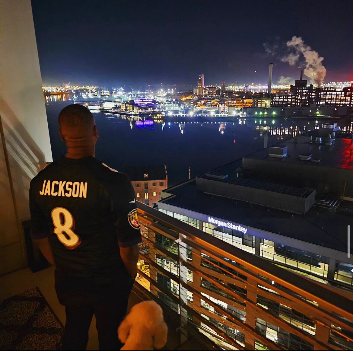 Mark Anthony Thomas overlooking the city of Baltimore from his apartment, sporting a Lamar Jackson jersey