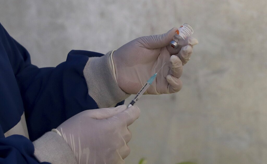 A health worker prepares a COVID-19 vaccine.