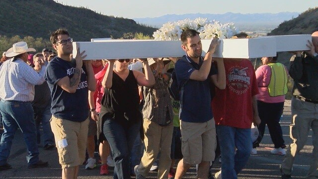 Dozens carry cross up A-mountain on Good Friday