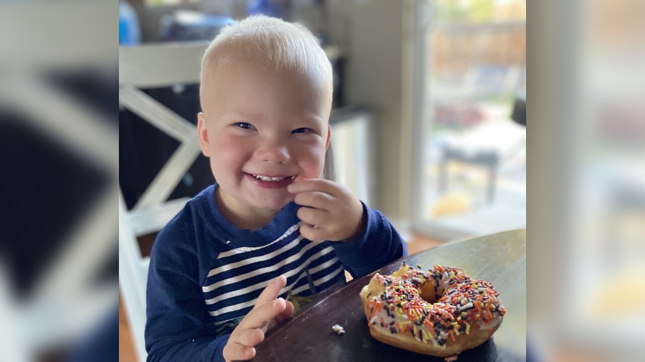 Brie's kid eating a donut.jpg