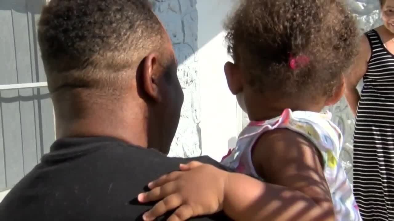Carlos Jimenes Martins holds daughter, Sarah Jimenes Carvalho, in April 2020