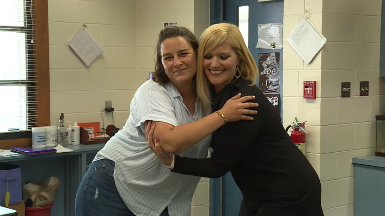 Principal Jenni Ellis and agriculture paraprofessional Anna Plummer of Everglades Elementary School in Okeechobee County hug on April 27, 2022.jpg