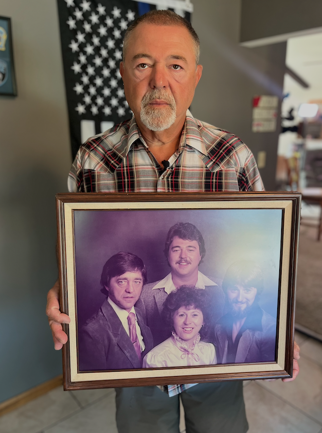 Bob Gelden holding family photo.png
