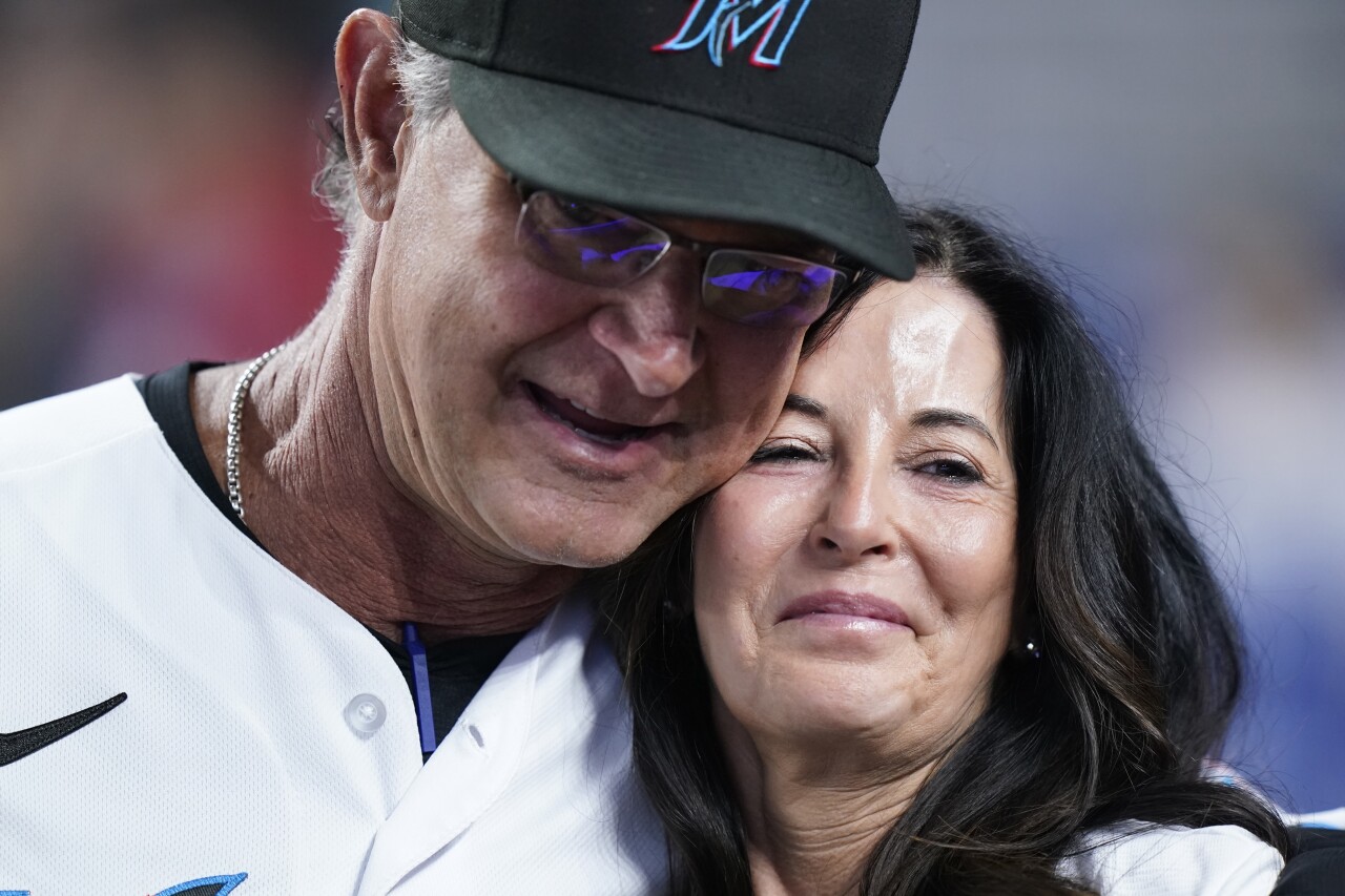 Miami Marlins manager Don Mattingly with wife Lori Mattingly as he's honored during final game, Oct. 5, 2022