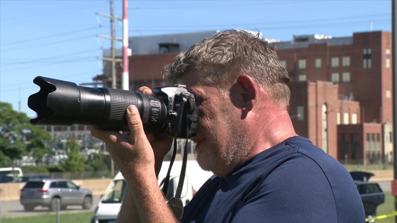 Chris Skelley takes pictures of planes during the Cleveland National Air Show from the edge of Kirtland Park.