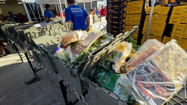Volunteers help distribute free groceries at Tangerine Plaza in St. Pete
