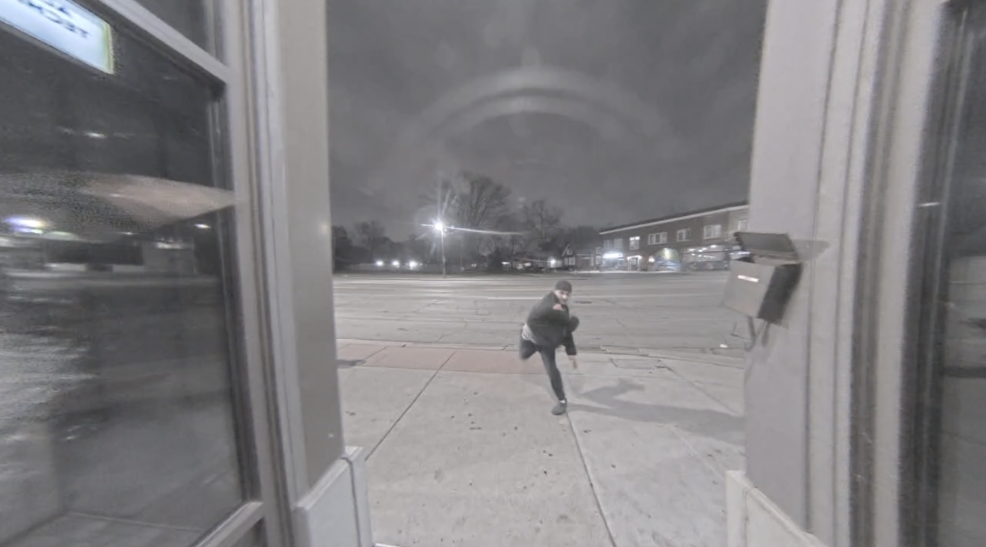 Suspect throwing a brick through the front window of All About Technology