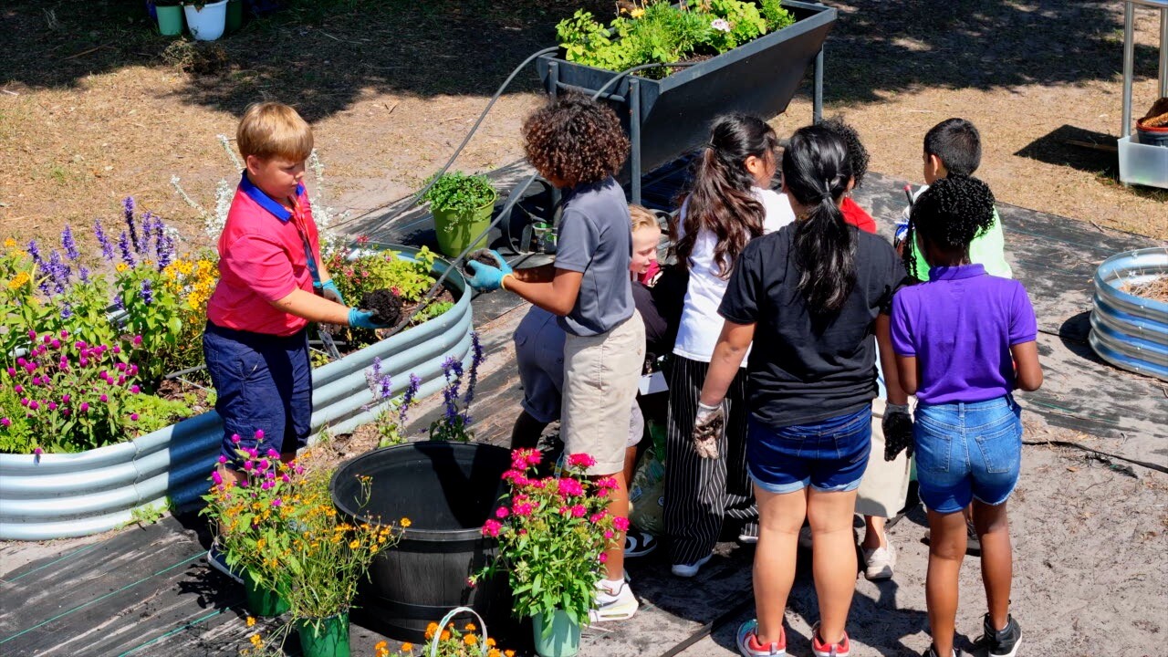 Central Elementary students working together to pot new plants.