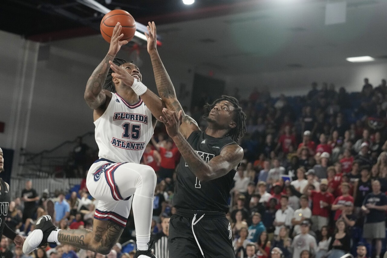 Florida International Panthers guard Dashon Gittens fouls Florida Atlantic Owls guard Alijah Martin, Dec. 13, 2023