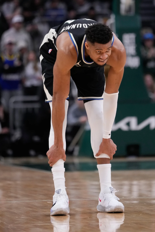 Milwaukee Bucks' Giannis Antetokounmpo holds his leg in the final seconds of the second half of an NBA basketball game against the Denver Nuggets Friday, Jan. 23, 2026, in Milwaukee.