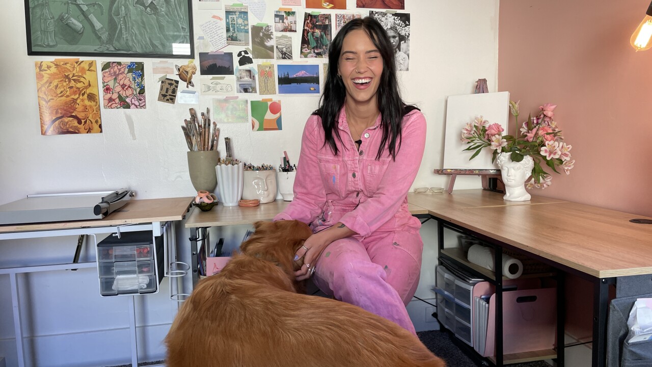 Paige Rochefort in her at-home studio with her pup Henry by her side