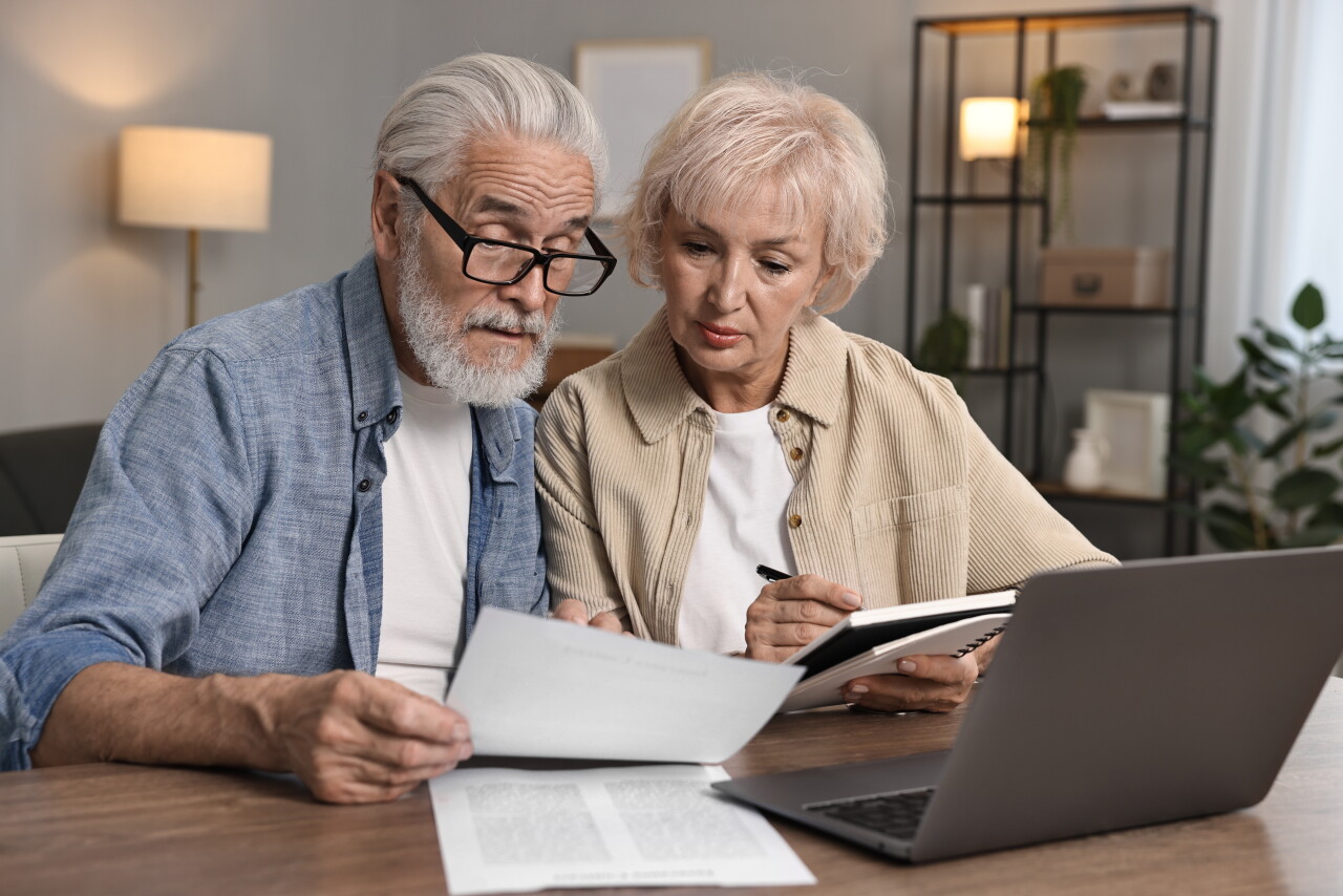 Pension,Savings.,Senior,Couple,Planning,Budget,At,Wooden,Table,Indoors