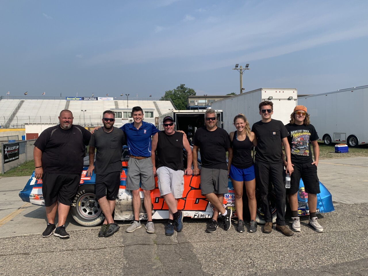 Harig poses with those helping at Berlin Raceway