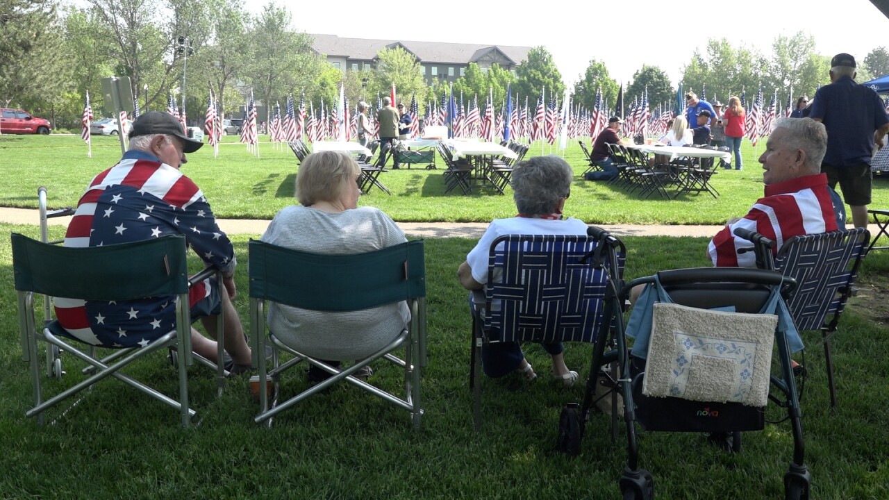 A pair of veterans and their wives relax in front of the Field of Honor