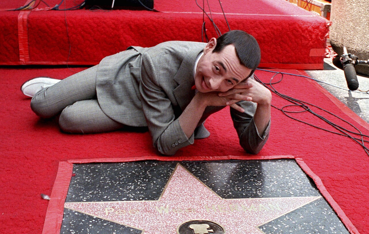 Paul Reubens, dressed as Pee-wee Herman, admires his star on the Hollywood Walk of Fame in 1988
