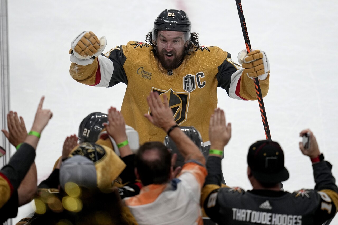 Vegas Golden Knights right wing Mark Stone celebrates with fans after a teammate's goal against the Florida Panthers during the second period of Game 1 of the NHL hockey Stanley Cup Finals, Saturday, June 3, 2023, in Las Vegas. (AP Photo/Abbie Parr)