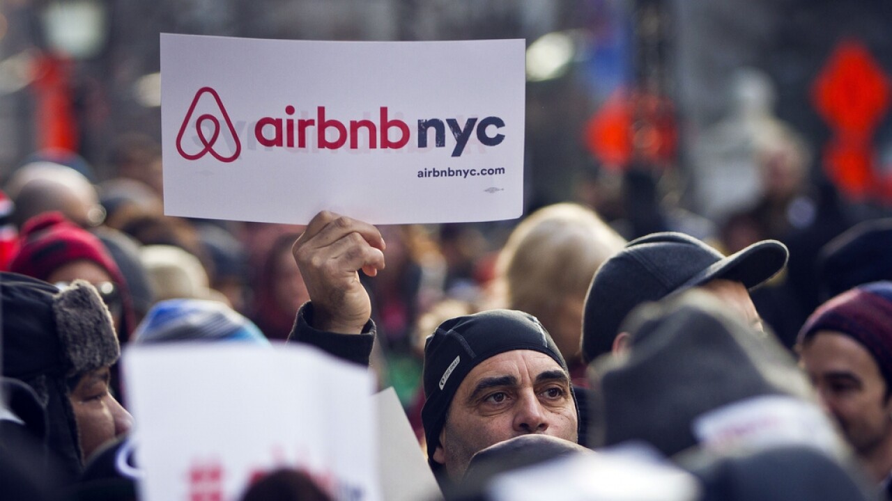 Supporters of Airbnb hold a rally outside City Hall in New York.