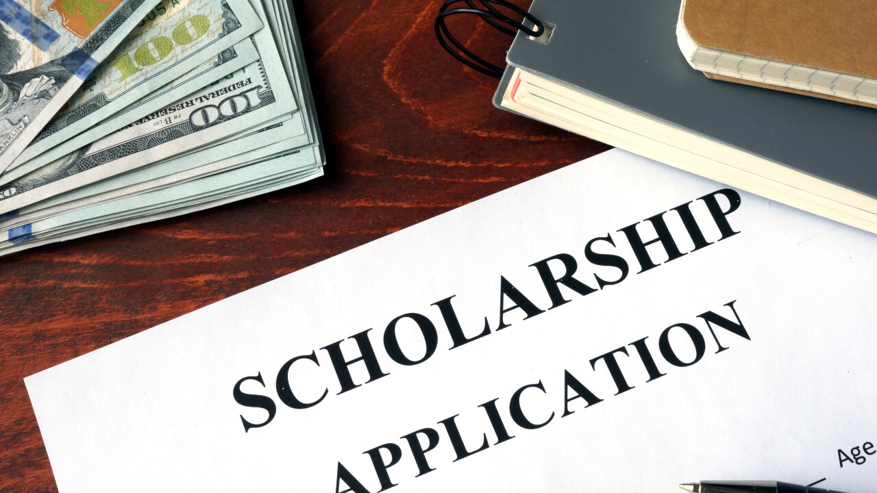 Scholarship Application on a table and dollars.