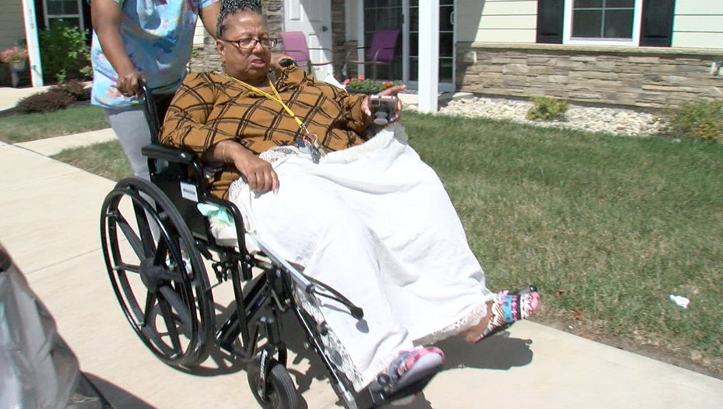 Judith Turner, pushed by her daughter, to the front of her complex in Hamilton where she waits for rides.