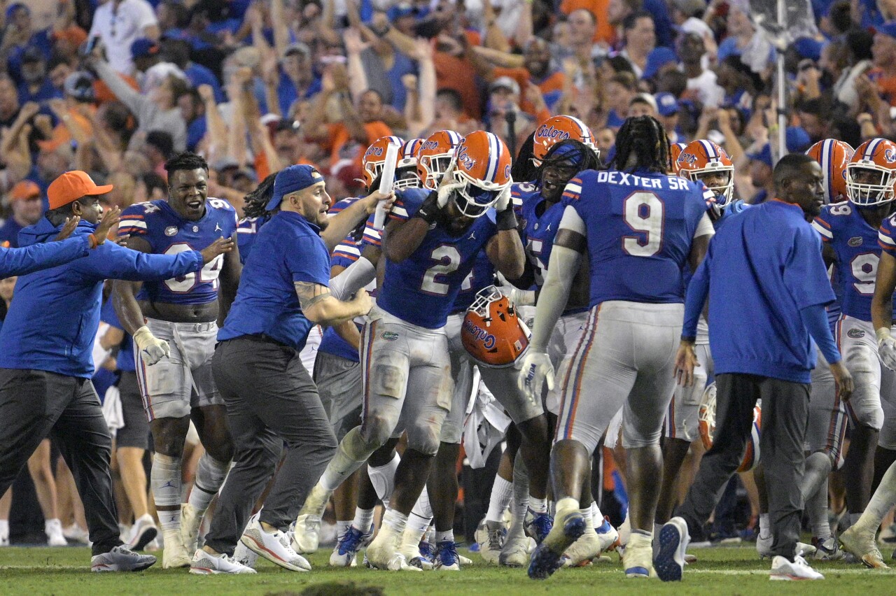 Florida Gators linebacker Amari Burney swarmed by teammates after game-winning interception vs. Utah Utes, Sept. 3, 2022