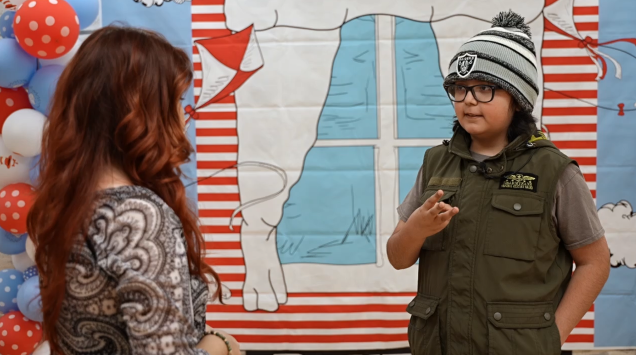 Neighborhood News Reporter Ruby Rivera interviewing spelling bee winner Sebastian Millan in Delano