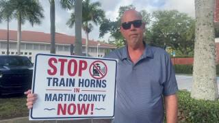 resident with stop train horns sign in Martin County May 19 2026.jpg
