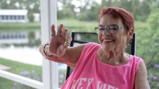 Rosie Quaranta holds up her wedding rings — one of the few treasures recovered from the debris after the tornado destroyed her home.