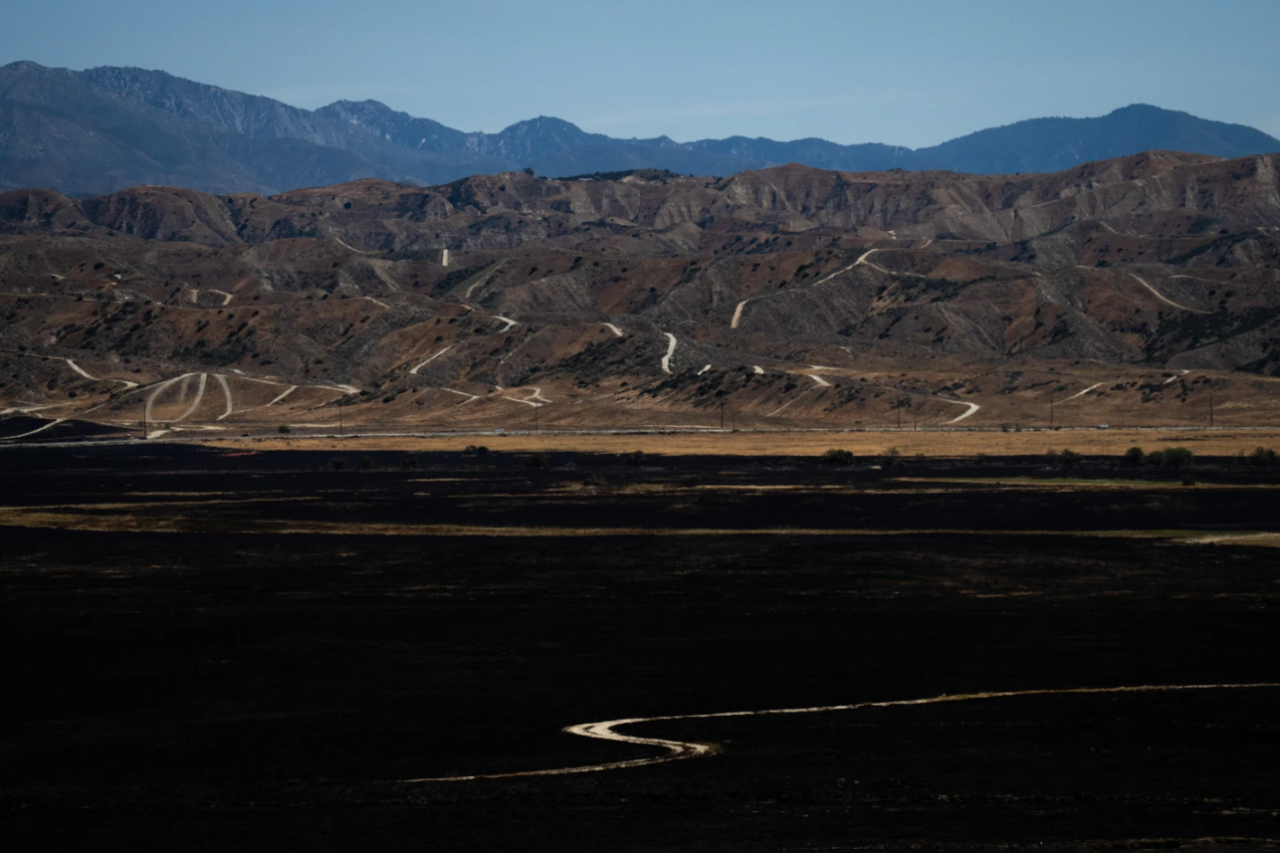 A charred field is seen after the Springs Fire in Moreno Valley, Calif., Saturday, April 4, 2026.