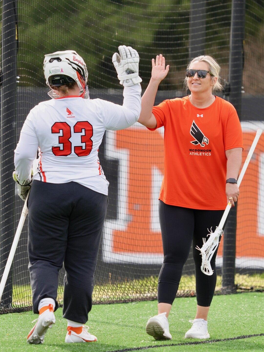 Wills hi-fiving a player on the field
