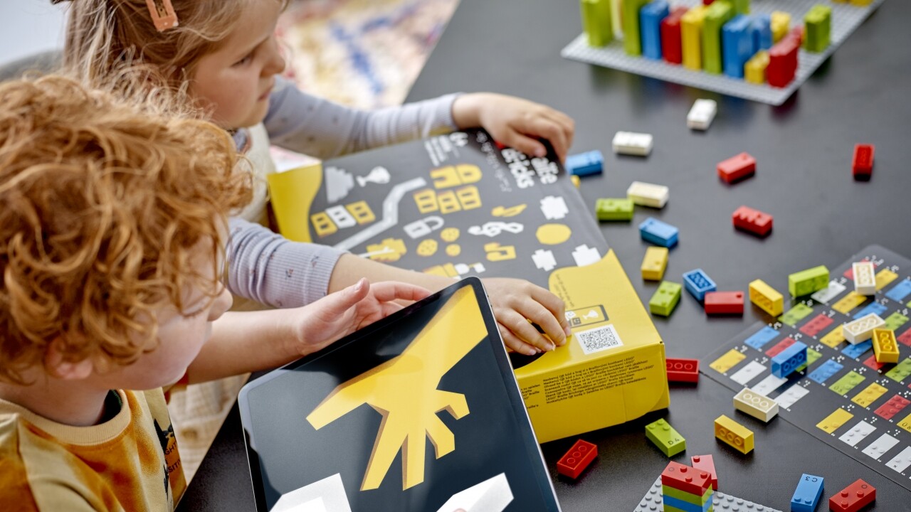 Children playing with Lego Braille Bricks.