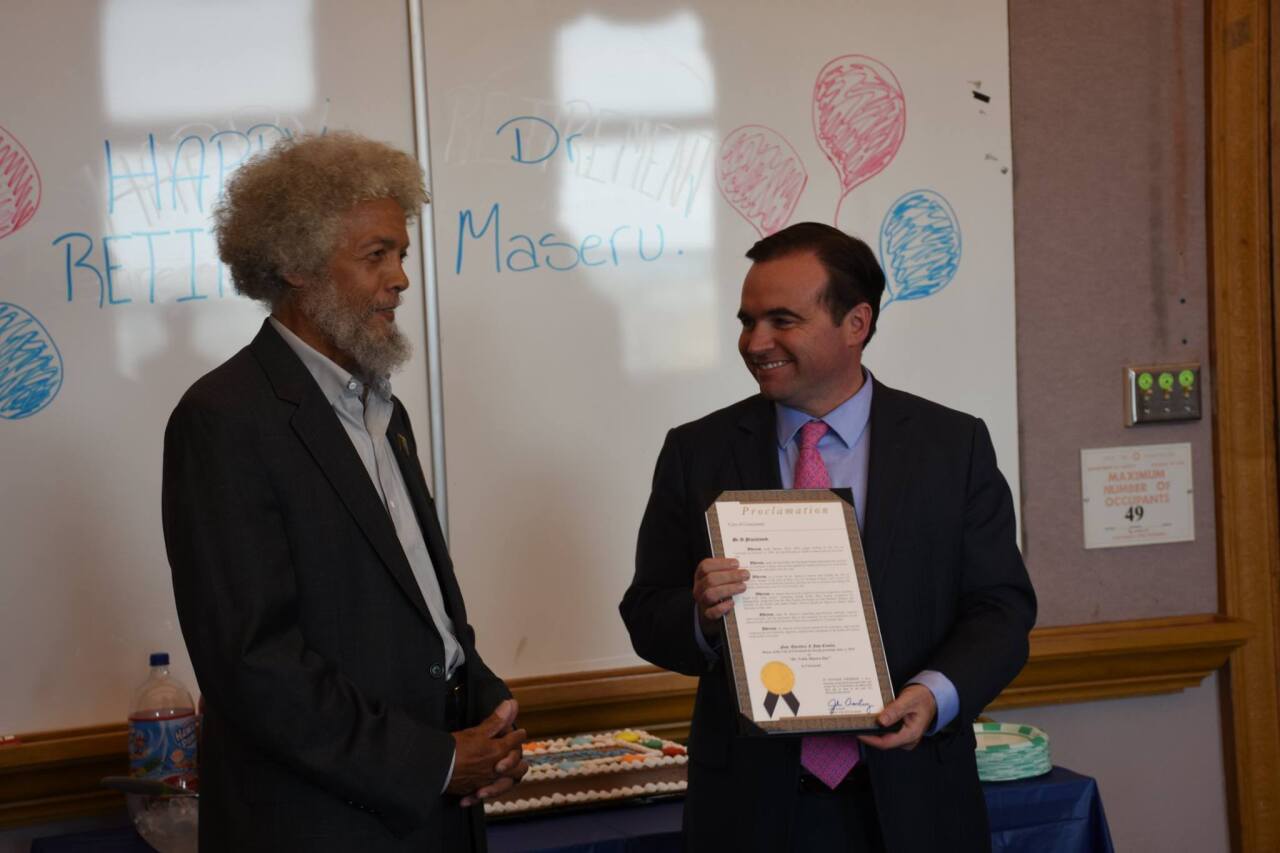 Former Cincinnati Mayor John Cranley gives a proclamation to honor former health commissioner Noble Maseru in May 2016.