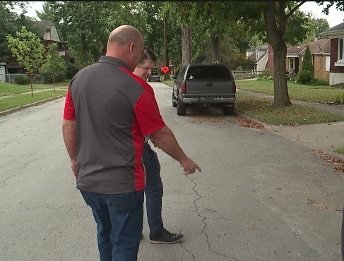 Jim Adams, showing WCPO 9 News reporter Sam Harasimowicz, shattered glass left by his daughter's damaged car window