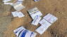 Mail-in ballots strewn along North County road