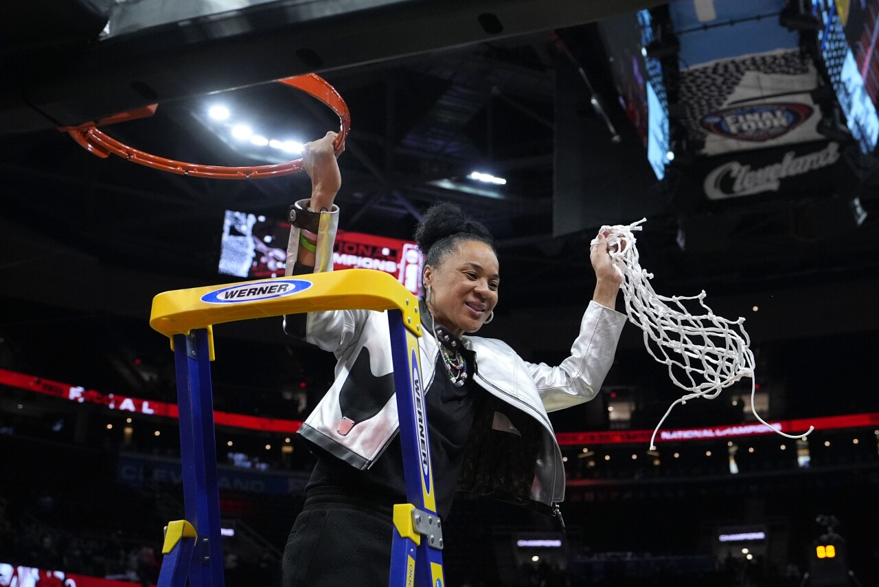 South Carolina Gamecocks women's basketball coach Dawn Staley holds net she cut down after winning national championship, April 7, 2024