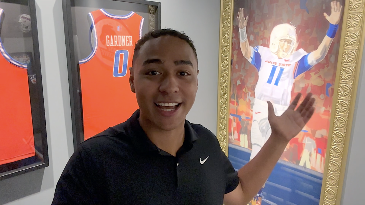 Idaho News 6 reporter, Brendyn Jones, selfie with huge Kellen Moore painting.