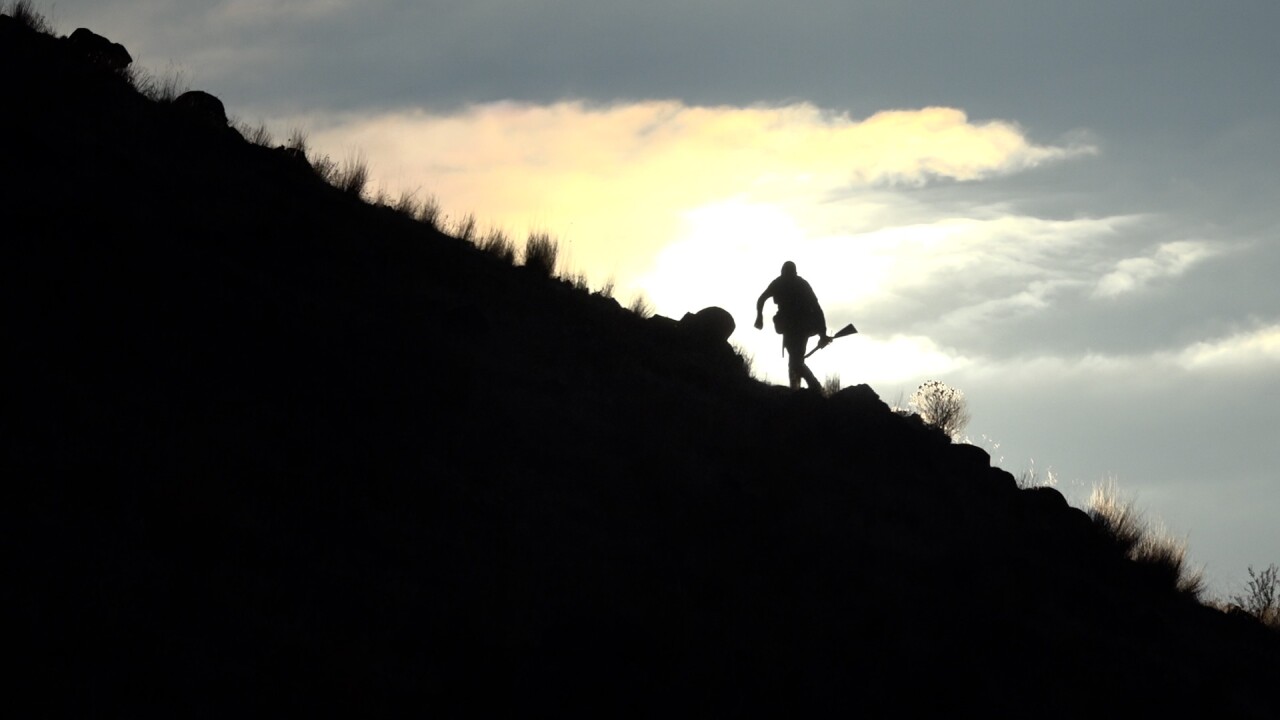 Climbing steep terrain early in the morning to hunt for chukars