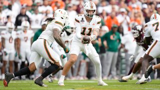 Miami quarterback Carson Beck (11) hands the ball off to running back Mark Fletcher Jr. (4) during the first half of the first round of the College Football Playoff against Texas A&M, Saturday, Dec. 20, 2025, in College Station, Texas. (AP Photo/Karen Warren)
