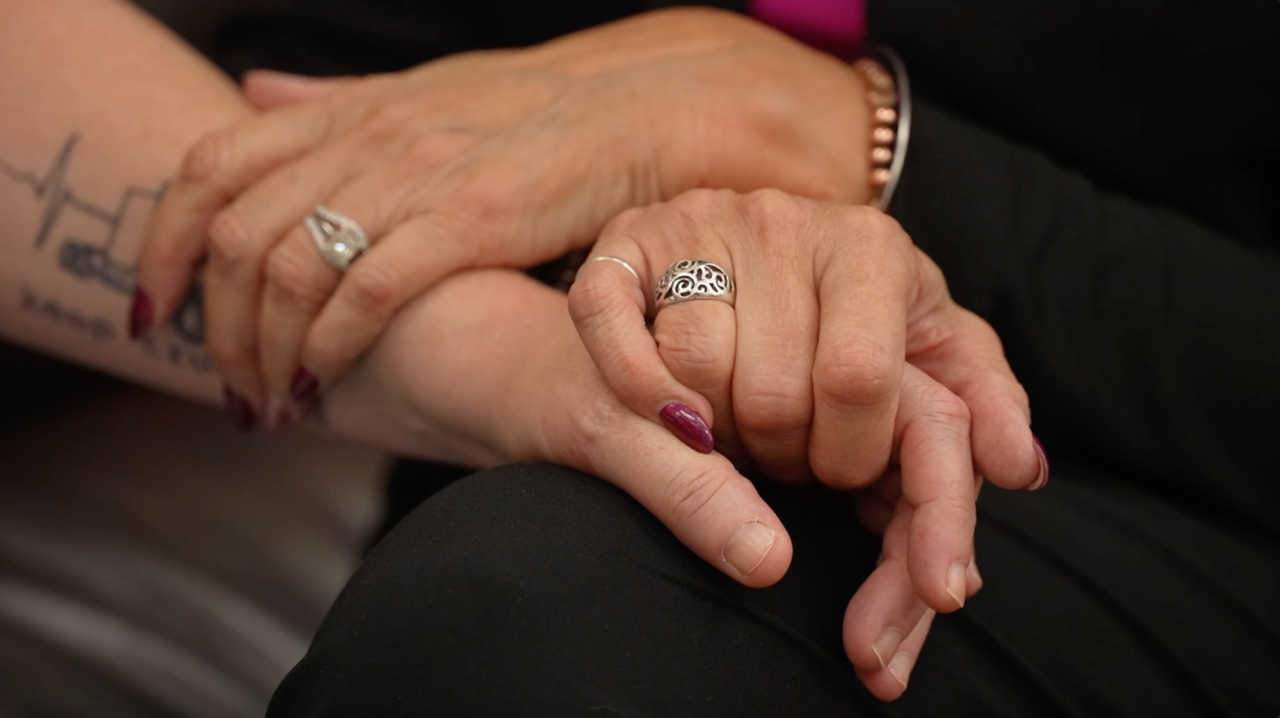 Kriston Lowrance and Ella Staples holding hands