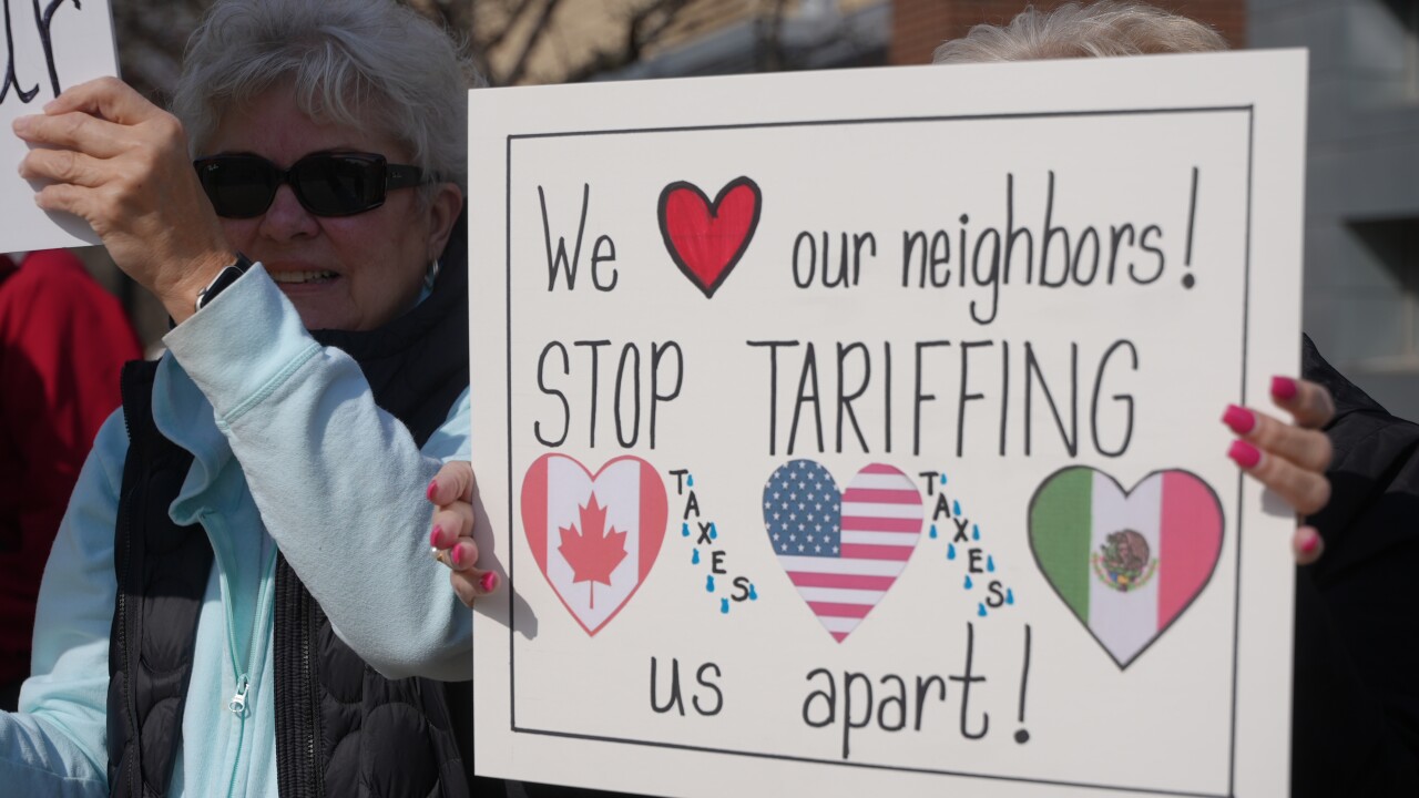 Protest outside of Rep. Bill Huizenga's office in Holland