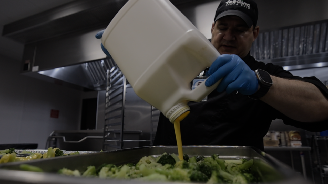 A chef at Feeding Tamp Bay preparing a meal inside their mega-kitchen.
