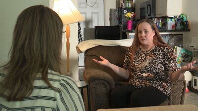 Cherie Jackson (right) speaks with WPTV chief investigator about her unemployment benefit struggles.
