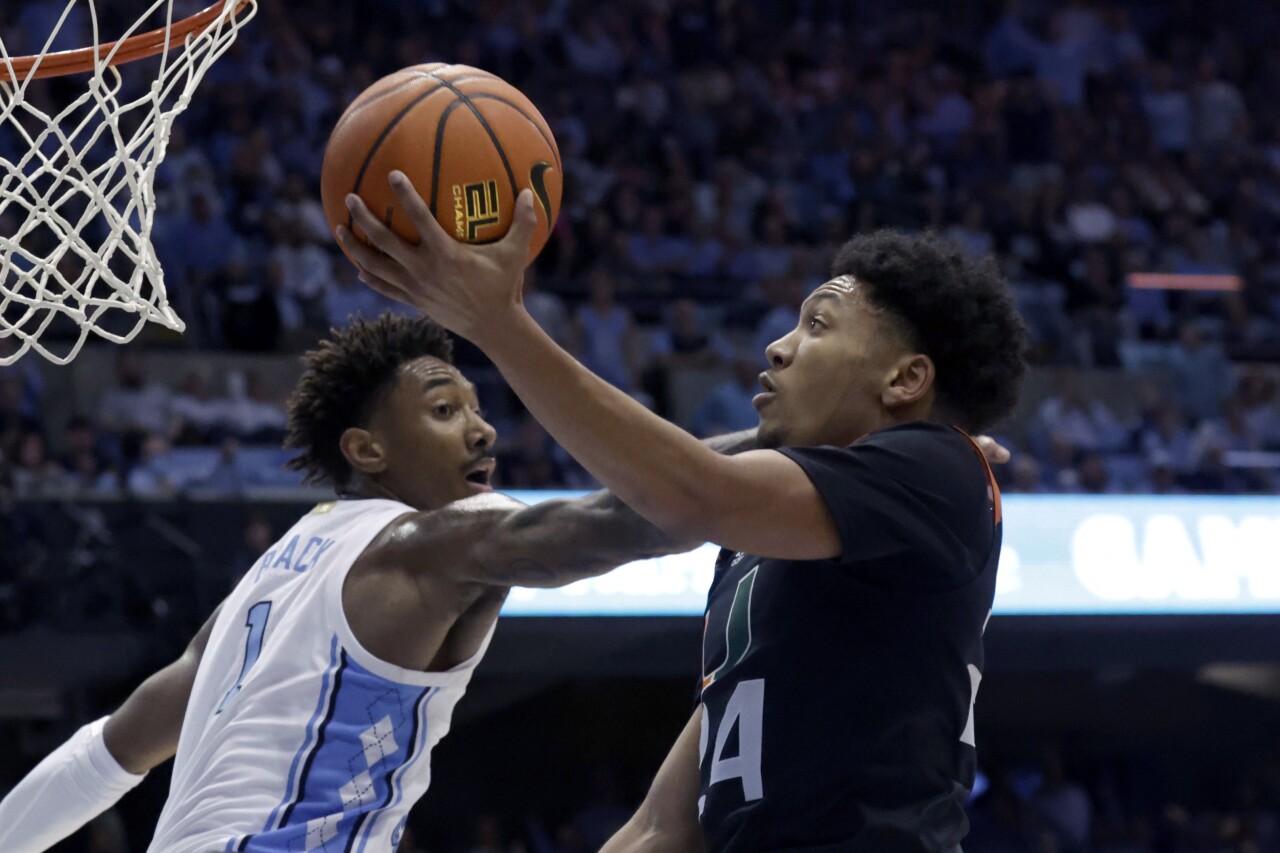 Miami Hurricanes guard Nijel Pack drives against North Carolina Tar Heels forward Leaky Black, Feb. 13, 2023, in Chapel Hill, N.C.