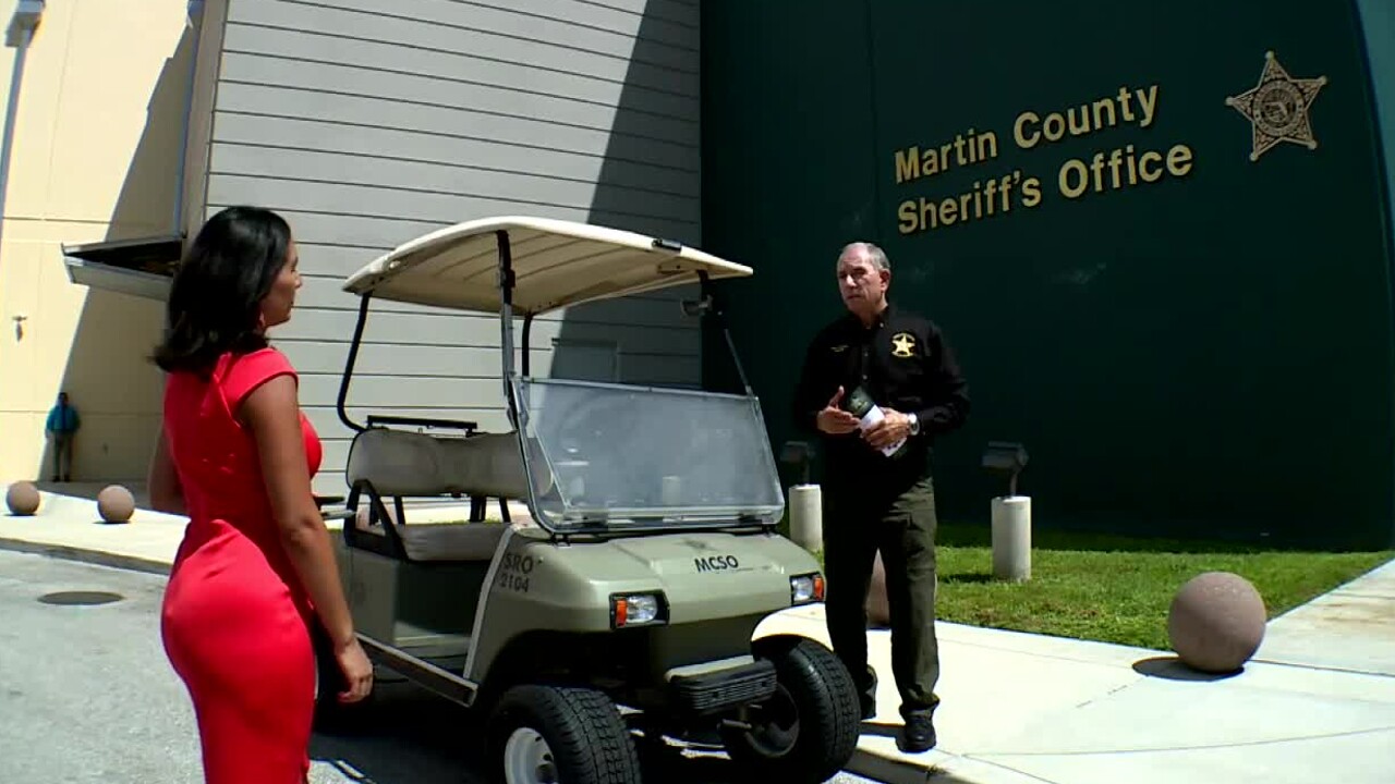 Martin County Sheriff William Synder speaks to Michelle Quesada while standing near golf cart on Aug. 15, 2022.jpg
