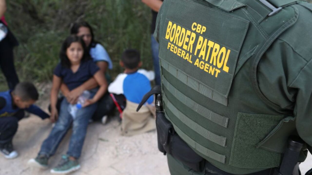 roughly 150 migrants attempt to climb border fence throw rocks at
