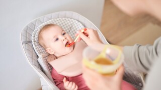 Mother feeding her baby daughter