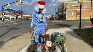 "The Real Hood Santa" rides down Fillmore with his Reindogs passing out goodies