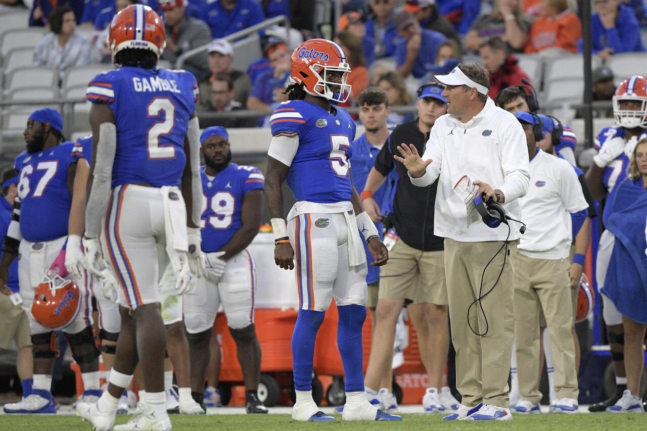 Florida Gators head coach Dan Mullen speaks to QB Emory Jones during game against Georgia Bulldogs in 2021
