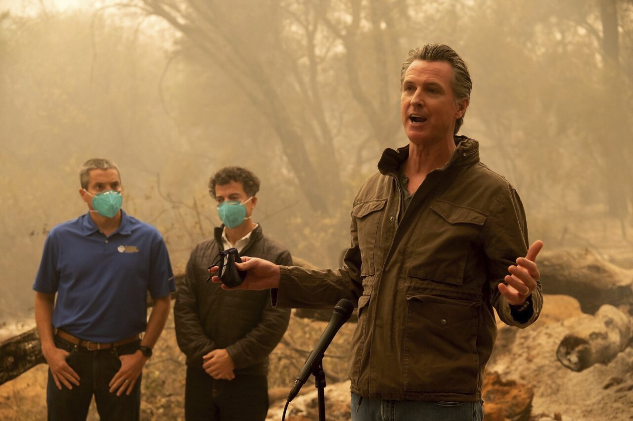 Gov. Gavin Newsom talk to the media after he toured the North Complex Fire zone with California Secretary for Natural Resources Wade Crowfoot, left, and California Secretary for Environmental Protection Jared Blumenfeld in Butte County on Friday, Sept. 11, 2020, outside of Oroville, Calif. (Paul Kitagaki Jr./The Sacramento Bee via AP, Pool)